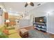 Open-concept living room with wood floors, ceiling fan, and view into the kitchen offering a comfortable living space at 2513 Martucci Rd, Seffner, FL 33584