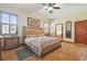 Spacious main bedroom features a large bed, stylish decor, and wood floors with natural lighting from the windows at 2513 Martucci Rd, Seffner, FL 33584