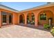 Covered patio with comfortable seating and arched doorways provides a cozy outdoor living space at 2513 Martucci Rd, Seffner, FL 33584