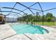Enclosed swimming pool with waterfall feature, paved surround, and black metal frame at 2513 Martucci Rd, Seffner, FL 33584