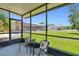 A sun filled screened-in porch with views of the yard and neighboring houses at 2513 Martucci Rd, Seffner, FL 33584