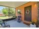 An inviting screened-in porch with neutral decor and a 'wipe your paws' door mat at 2513 Martucci Rd, Seffner, FL 33584