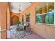 Inviting covered porch with seating, a decorative rug, and a classic wooden front door at 2513 Martucci Rd, Seffner, FL 33584