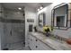 Modern bathroom featuring a frameless shower, decorative mirrors, and dual sinks at 29524 Waggle Dr, San Antonio, FL 33576