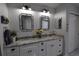 Bright bathroom with dual sinks, modern fixtures, and a charming beach house aesthetic at 29524 Waggle Dr, San Antonio, FL 33576