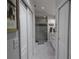 Bright bathroom featuring a walk-in shower with gray tiling and dual sink vanity at 29524 Waggle Dr, San Antonio, FL 33576