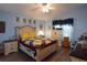 Comfortable bedroom featuring a decorative quilt, a ceiling fan, and light blue walls at 29524 Waggle Dr, San Antonio, FL 33576