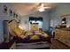 Spacious bedroom featuring a decorative quilt, wood floors, and a ceiling fan at 29524 Waggle Dr, San Antonio, FL 33576
