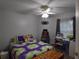 Bright bedroom with a ceiling fan, a window, and sewing equipment on a table at 29524 Waggle Dr, San Antonio, FL 33576