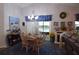 The dining room includes a chandelier, a table with chairs, and sliding glass doors to the lanai at 29524 Waggle Dr, San Antonio, FL 33576
