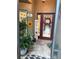 Inviting entryway with decorative signs, plants, and a charming welcome sign at 29524 Waggle Dr, San Antonio, FL 33576