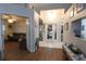 Bright entryway featuring wood laminate floors, a white door with glass, and white tile flooring at 29524 Waggle Dr, San Antonio, FL 33576