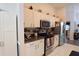Efficient kitchen featuring white cabinets, dark countertops, and stainless steel appliances at 29524 Waggle Dr, San Antonio, FL 33576