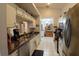 Bright kitchen features white cabinetry, stainless steel appliances, and modern fixtures at 29524 Waggle Dr, San Antonio, FL 33576