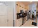 Well-lit kitchen featuring white cabinetry, stainless steel appliances, and dark countertops at 29524 Waggle Dr, San Antonio, FL 33576