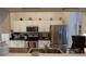 Charming kitchen featuring white cabinets, stainless steel appliances, and fun birdhouse accents at 29524 Waggle Dr, San Antonio, FL 33576