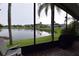 Screened lanai with a view of a pond and palm trees at 29524 Waggle Dr, San Antonio, FL 33576