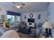 Inviting living room featuring a ceiling fan, television, and sliding glass doors to the patio at 29524 Waggle Dr, San Antonio, FL 33576