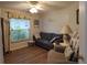 Cozy living room features hardwood floors, a comfortable couch, and a bright window at 29524 Waggle Dr, San Antonio, FL 33576