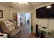 Cozy living room with a recliner and a doorway to the dining area at 29524 Waggle Dr, San Antonio, FL 33576