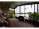 Enclosed patio featuring brick pavers and lovely lake view at 29524 Waggle Dr, San Antonio, FL 33576
