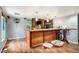 Spacious home bar features wood counter, pendent lighting, and hardwood style floors at 36251 Horseshoe Dr, Zephyrhills, FL 33541