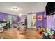 Colorful bedroom with two entryways, hard floors, and a large flat screen television at 36251 Horseshoe Dr, Zephyrhills, FL 33541