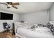 Bedroom with ceiling fan, hard floors, and a large television mounted on the wall at 36251 Horseshoe Dr, Zephyrhills, FL 33541