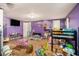 Colorful bedroom featuring hardwood floors, bunk beds, and a flat screen television on the wall at 36251 Horseshoe Dr, Zephyrhills, FL 33541