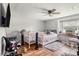 Cozy bedroom with wood-look floors, ceiling fan, and a bright window, providing ample light at 36251 Horseshoe Dr, Zephyrhills, FL 33541