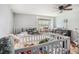 Bedroom featuring a window, ceiling fan and a dresser at 36251 Horseshoe Dr, Zephyrhills, FL 33541