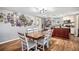 Bright dining area with hardwood floors and neutral paint, adjacent to kitchen for easy serving at 36251 Horseshoe Dr, Zephyrhills, FL 33541