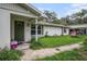 Lovely front exterior featuring a covered entry, well-maintained lawn, and charming details at 36251 Horseshoe Dr, Zephyrhills, FL 33541