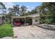 Two-car garage with a pink vehicle, and an open workspace at 36251 Horseshoe Dr, Zephyrhills, FL 33541