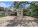 Two-car garage with a pink vehicle, and an open workspace at 36251 Horseshoe Dr, Zephyrhills, FL 33541