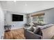 Comfortable living room featuring a large window and a flatscreen television mounted on the wall at 36251 Horseshoe Dr, Zephyrhills, FL 33541