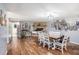 Cozy living room and dining space with a stone fireplace, hardwood floors, and bright natural lighting at 36251 Horseshoe Dr, Zephyrhills, FL 33541