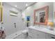 Modern bathroom features a sleek shower, white vanity, and stylish design at 4525 W Swann Ave, Tampa, FL 33609