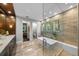 Elegant bathroom boasting a soaking tub, marble counters, and a vanity at 4525 W Swann Ave, Tampa, FL 33609