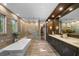 Large bathroom with a soaking tub, marble counters, and a large vanity at 4525 W Swann Ave, Tampa, FL 33609