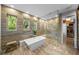 Bright bathroom features a soaking tub, walk-in shower, and direct access to the closet at 4525 W Swann Ave, Tampa, FL 33609