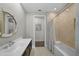 Bathroom featuring a tub-shower combo, spacious vanity, and bright lighting at 4525 W Swann Ave, Tampa, FL 33609