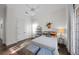Cozy bedroom featuring hardwood floors, neutral walls, ceiling fan, and abundant natural light at 4525 W Swann Ave, Tampa, FL 33609