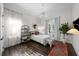 This charming bedroom features hardwood floors, decorative furnishings, and an abundance of natural light at 4525 W Swann Ave, Tampa, FL 33609