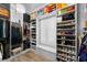Walk-in closet featuring organized storage with shelves, drawers, and hanging rods at 4525 W Swann Ave, Tampa, FL 33609