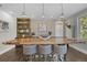 Dining area with a large live-edge wood table and bar seating adjacent to the kitchen at 4525 W Swann Ave, Tampa, FL 33609