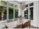 Bright dining room with large windows overlooking the pool and outdoor greenery at 4525 W Swann Ave, Tampa, FL 33609