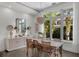 Dining room featuring a decorative lighting fixture, large windows, and modern décor at 4525 W Swann Ave, Tampa, FL 33609