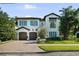 Charming two-story home with a paver driveway, attached two-car garage, and beautifully landscaped yard at 4525 W Swann Ave, Tampa, FL 33609