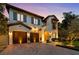 Elegant two-story home featuring a paver driveway, lush landscaping, and a charming architectural design at 4525 W Swann Ave, Tampa, FL 33609